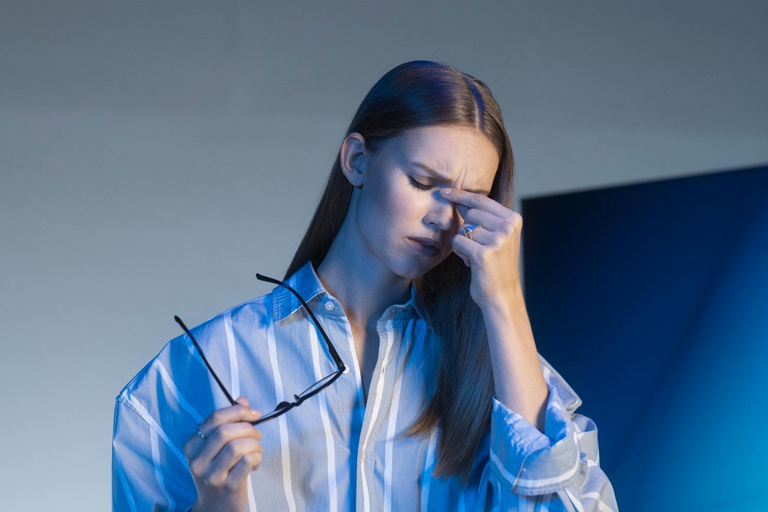 Young woman suffering from eye strain