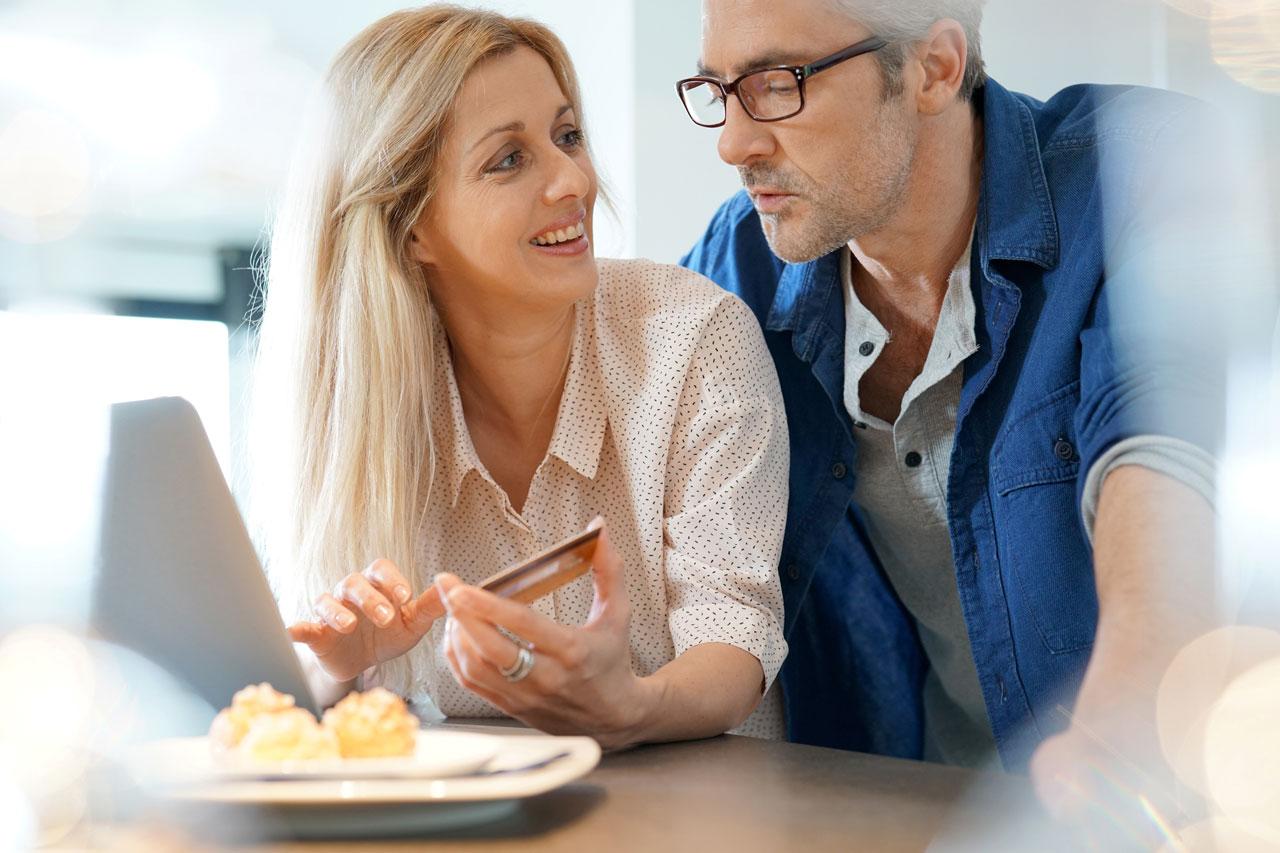 Middle-aged couple at home shopping on internet