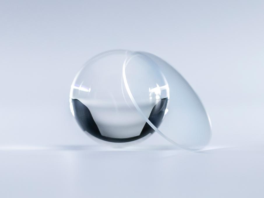 A lens with ZEISS Platinum coating is crystal clear with no reflections compared to the glass ball next to it.