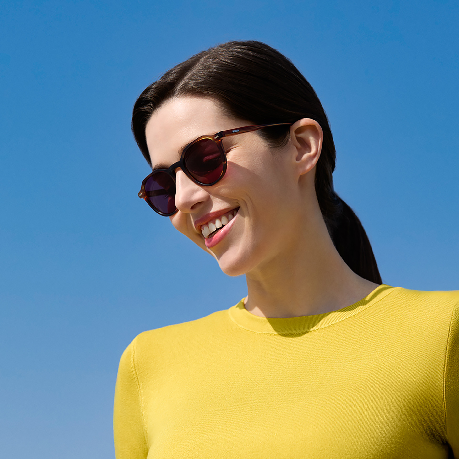 Women with big, dark tinted sunglasses.