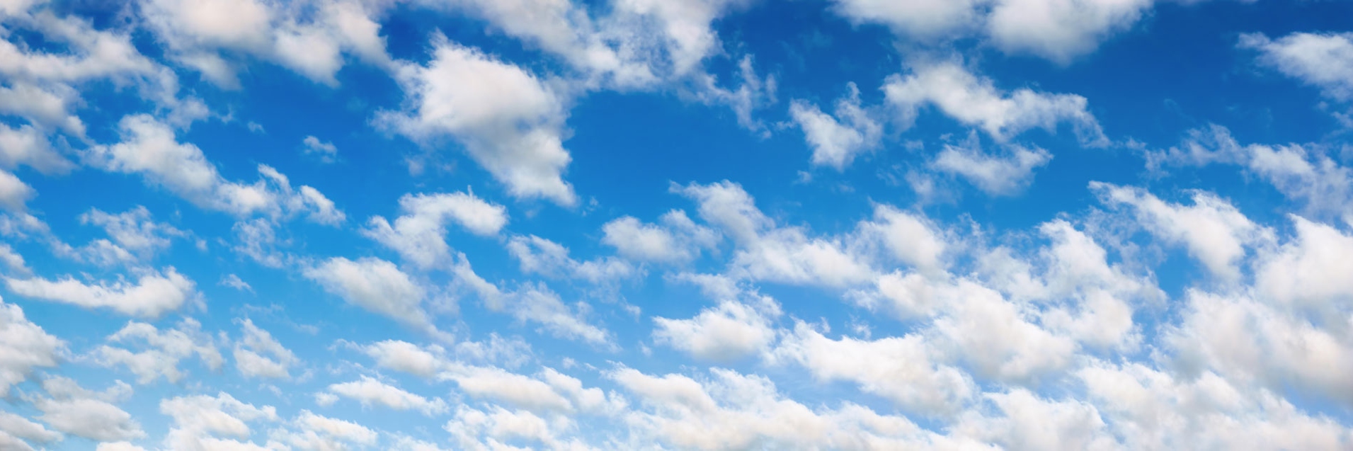 Fluffy white clouds on blue sky panorama